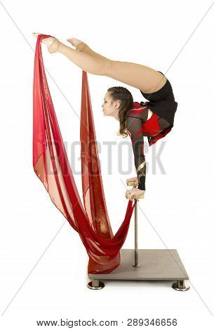 Flexible Equilibrist Performs Exercises On Acrobatic Walking Sticks. Studio Photo On White Backgroun