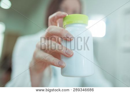 Doctor Recommends Vitamin Supplements, Close Up Of Female General Practitioner Holding A Bottle Of T