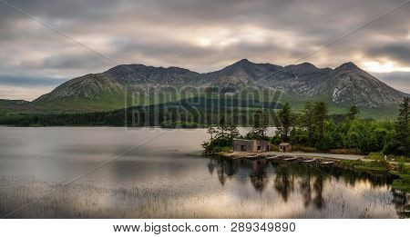 Beautiful Lake Called Lough Inagh In County Galway, Ireland With A Cabin And Boats At The Lake Shore