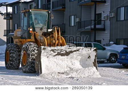Fargo, North Dakota, March 11, 2019: A Huge 4-wheel Drive Tractor(644h) With A Massive Bucket For Sn