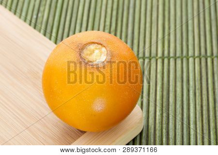 Fruits And Slices Of Lulo Or Naranjilla On The Wooden Table - Solanum Quitoense