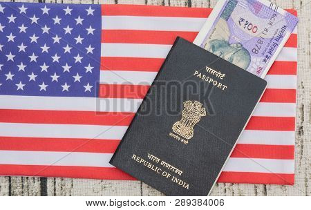 Indian Passport With Currency On Usa Or Americas Flag As A Background