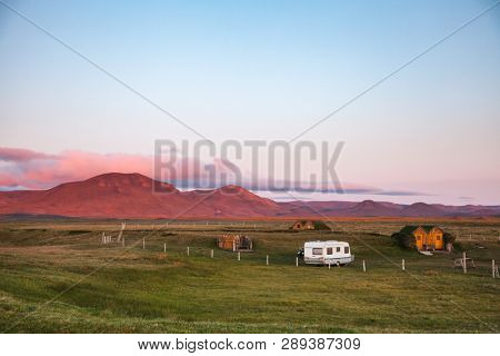 Camper trailer and turf roof wooden cabins at a campsite near Modrudalur farm, the highest inhabited settlement in Iceland, NorÃ°ur-MÃºlasÃ½sla, Eastern Iceland, Scandinavia