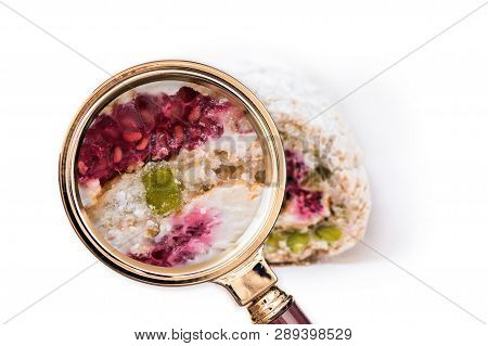Cake In The Magnifying Glass. Food Composition Analysis Concept.