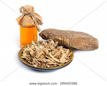 Agarwood, Also Called Aloeswood Oudh. With Essential Oil In Pharmaceutical Bottle. Isolated On White