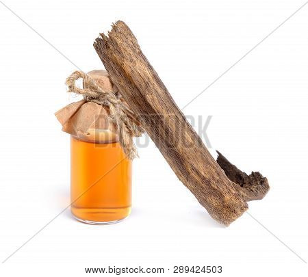 Agarwood, Also Called Aloeswood Oudh. With Essential Oil In Pharmaceutical Bottle. Isolated On White