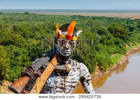Omo Valley, Korcho Village, Ethiopia - December 09, 2013: Unidentified Karo Man With A Gun And With 