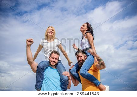 Twice Fun On Double Date. Couples In Love Having Fun. Men Carry Girlfriends On Shoulders. Summer Vac