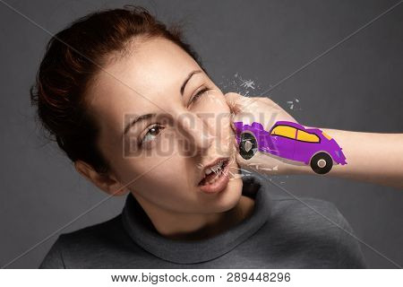 The Concept Of Car Accidents, Insurance Claims . Close-up Of The Accident.the Girl Is Hit By A Purpl