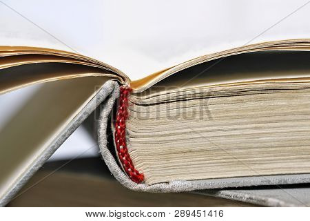 Opened Old Book In A Bright Cover Lies On The Table Close-up Design Blank For The Project
