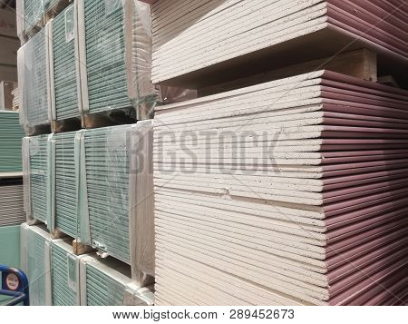 Wooden Bars At Lumber Yard Of Hardware Store. Rack Of Pre-cut Panel, Mill Wood Timber, Siding, Plywo
