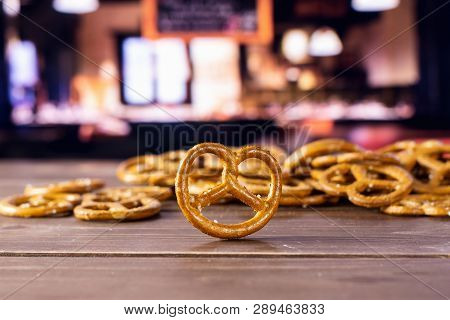 Lot Of Whole Mini Salted Pretzels One Is In A Forcus In A Restaurant