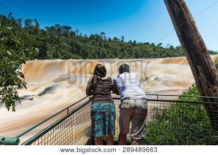 Man And Woman On The Saltos Del Monday A Waterfall Near The City Ciudad Del Este In Paraguay