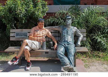 Key West, Florida, Usa - November 07, 2012: Man On A Bench With The Sculpture 