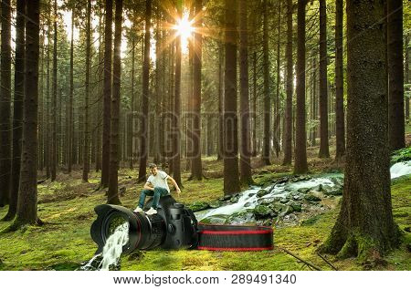 Man Sits On A Camera Through Which A Creek Flows Out Of Which A Waterfall Becomes.