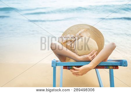 Summer Beach Vacation Concept, Asia Woman With Hat Relaxing And Arm Up On Chair Beach At Koh Mak, Tr