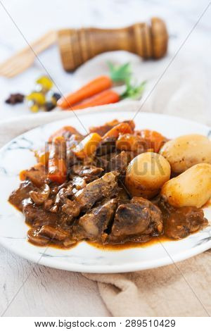 Beef meat stewed with potatoes-Traditional French cuisine Beef Bourguignon potatoes carrots in persillade