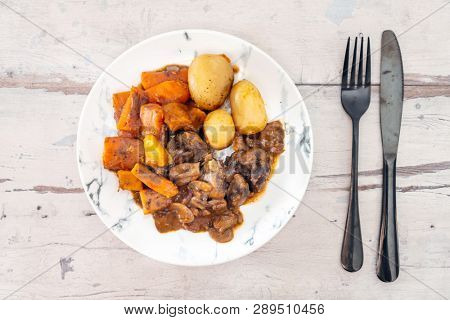 Beef meat stewed with potatoes-Traditional French cuisine Beef Bourguignon potatoes carrots in persillade