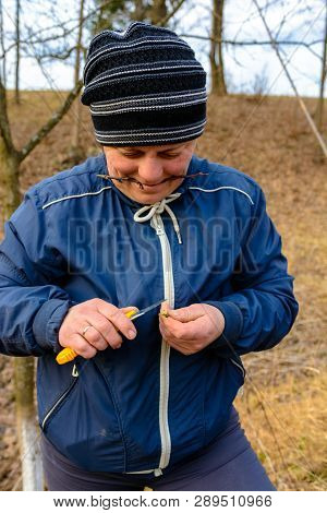 A Woman Gardener Cuts A Clip Of Wood For Vaccination With A Sharp Knife