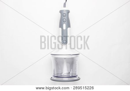 Electric Hand Blender Attached To A Chopping Bowl On White Background. Top View