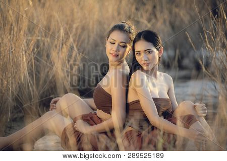 Asia Woman Beautiful Friend Happy Smiling Sitting On Grass Field Sunset Nature Background / Asian Gi