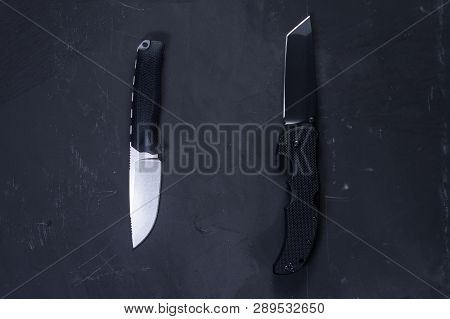 Two American knives. Fixed knife and folding knife. Comparison of two knives.