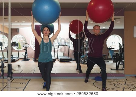 Fitness Parners In Sportswear Doing Exercises At Gym. Fitness Sport Gym Concept