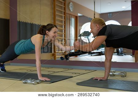 Fitness Parners In Sportswear Doing Exercises At Gym. Fitness Sport Gym Concept