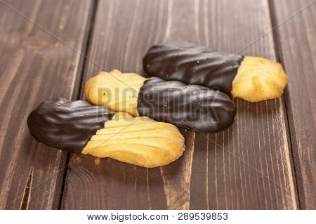Group Of Three Whole Lazy Cookie With Chocolate In Row On Brown Wood