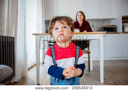 Little Todler Boy Stay At Kitchen In A Day And Watiching Something