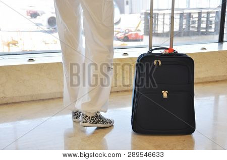 Traveler with a suitcase on the speedwalk
