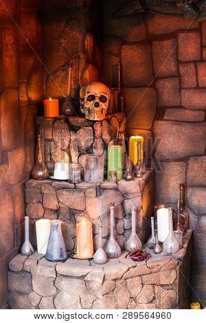 Medieval Arrangement Of Potions, Skull And Candles In A Dark Corner
