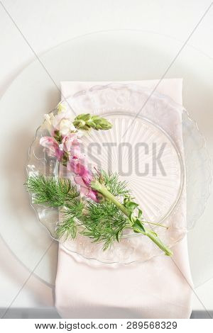 Closeup Table Setting With Plates And Tableware, Adorned With Flowers. Floral Decoration For Wedding