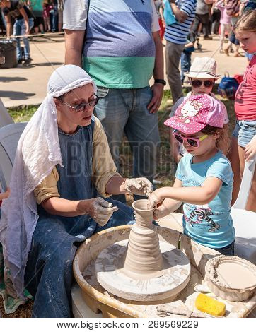 Goren, Israel, April 06, 2018 : A Knight Festival Participant Tells A Small Visitor How To Make A Cl