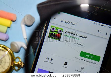Bekasi, West Java, Indonesia. March 15, 2019 : Zombie Tsunami Dev App With Magnifying On Smartphone 