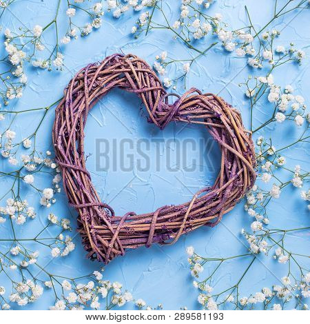Big Decorative Heart And Pattern From Fresh White Gypsofila  Flowers On Blue Textured Background. To