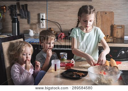 The Children In The Kitchen Independently Prepare Cookies, Squeeze Out The Form.
