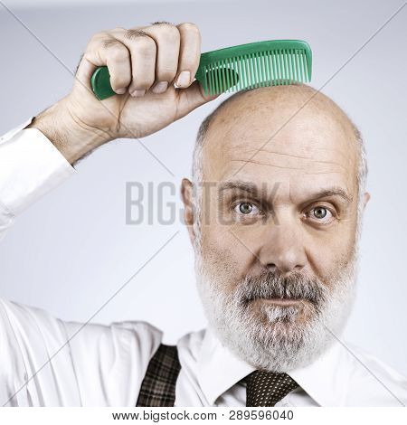Funny Bald Man Combing His Head