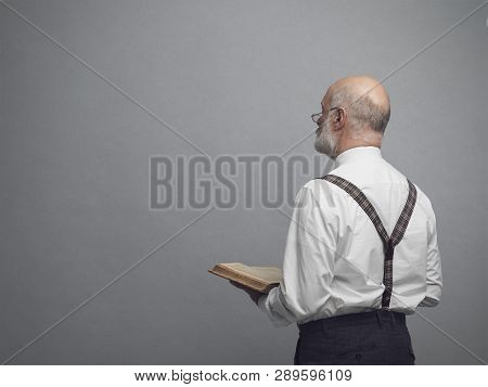 Academic Professor Teaching And Holding A Book