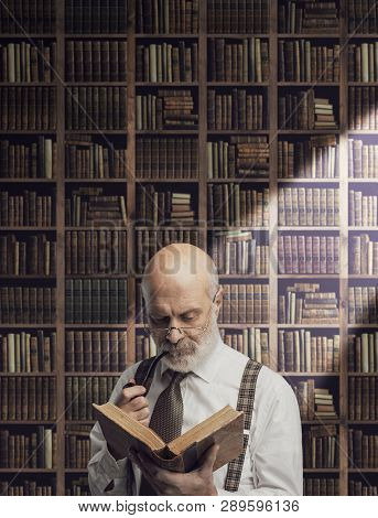Academic Professor In The Library Holding A Book