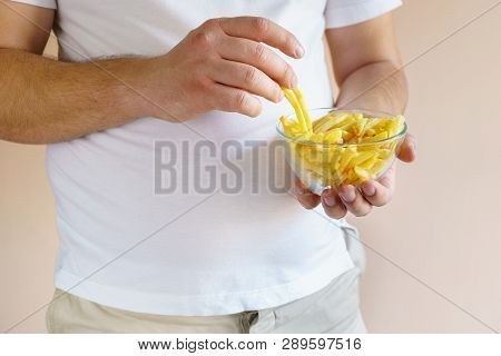 Processed Products, Fast Food, Unhealthy Diet, Imbalanced Ration. Overweight Man Eating Salted Fatte