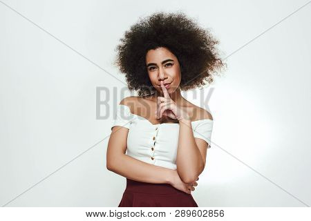 Dont Tell Anybody... Beautiful And Cute Afro American Woman Is Showing Tss And Smiling At Camera Whi