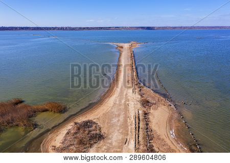 Off-piste. Deep Rubber Tracks On The Road Is Covered With Wet Dirty Sand, Off-road. Traces Of Tires 