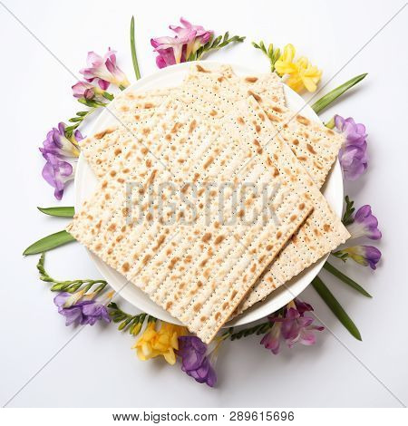Composition Of Matzo And Flowers On Light Background, Top View. Passover (pesach) Seder