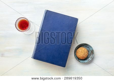 An Old Book With A Glass Of Dessert Wine And A Biscuit, Shot From Above With A Place For Text