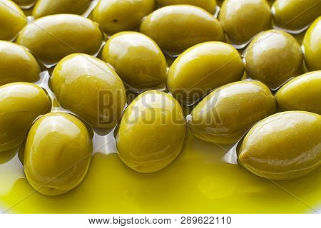 Extra Virgin Healthy Olive Oil With Fresh Olives In Plate Close Up