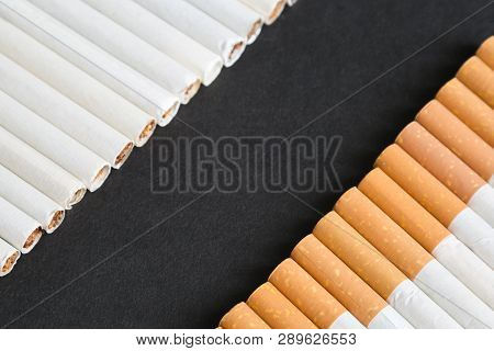 Place For Text Among Cigarettes And Tobacco, Black Background.