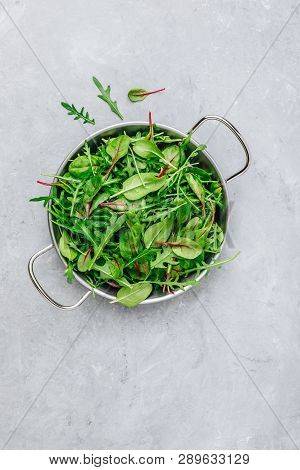 Mix Of Fresh Leaves With Arugula, Lettuce, Spinach, Beets. Ingredients For Salad On A Gray Stone Bac