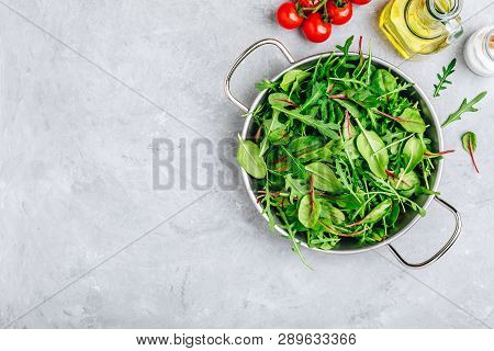 Mix Of Fresh Leaves With Arugula, Lettuce, Spinach, Beets. Ingredients For Salad On A Gray Stone Bac