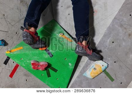 Rocky Shoe On A Tiny, Scanty Snare Stands With The Tip Of The Sock In Close-up On The Climbing Wall 